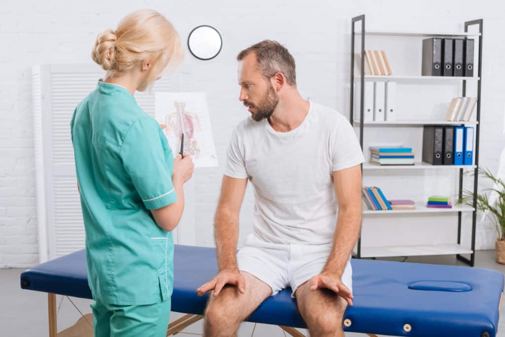 female physical therapist talking to patient 