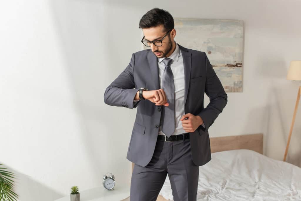 time conscious man in suit running out of time for physical therapy
