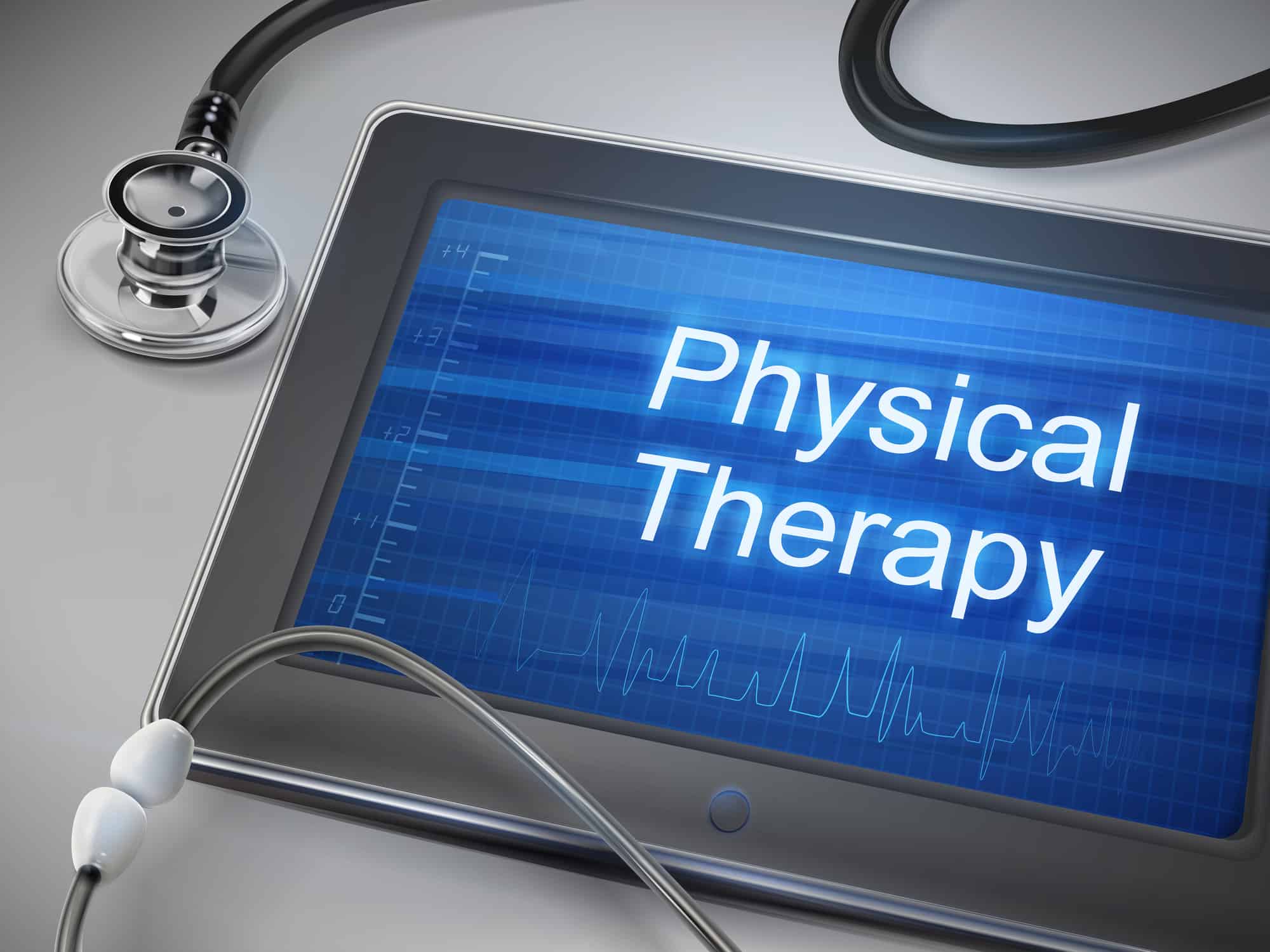 physical therapy words displayed on tablet with stethoscope over table